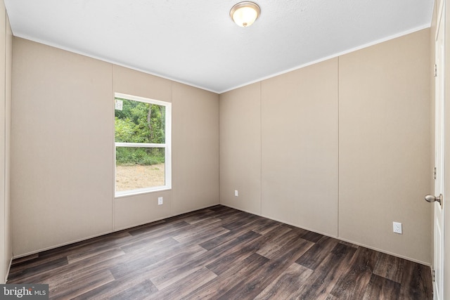 empty room with dark hardwood / wood-style flooring