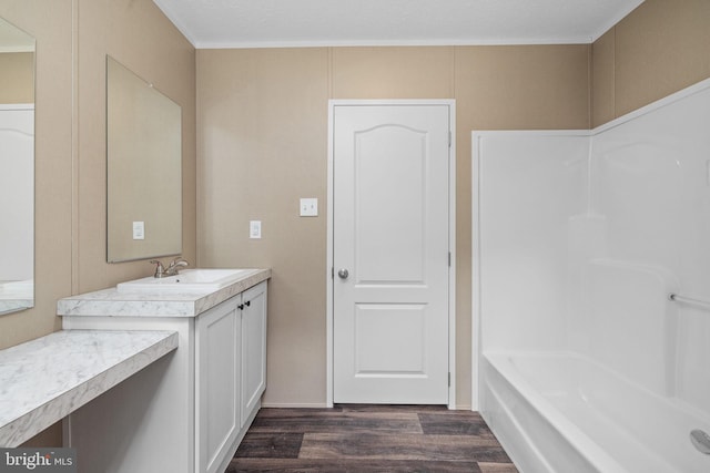 bathroom featuring hardwood / wood-style flooring, vanity, and a bathing tub