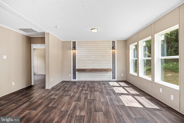 unfurnished living room with dark wood-type flooring