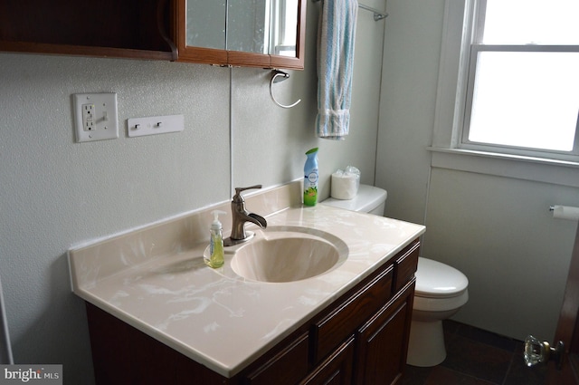 bathroom featuring vanity and toilet