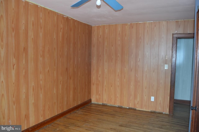 empty room with ceiling fan and hardwood / wood-style floors