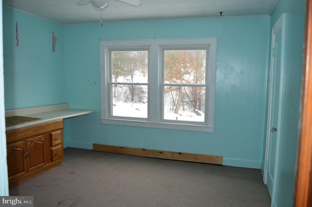 interior space featuring light carpet and ceiling fan