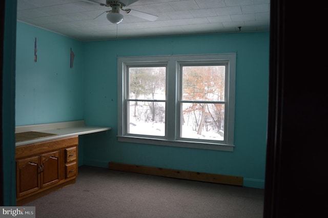 interior space with ceiling fan and light carpet