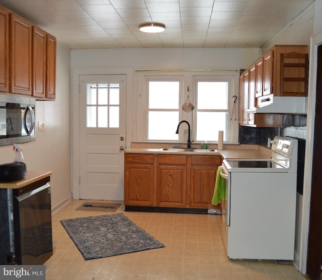 kitchen featuring white electric range oven and sink