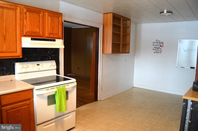 kitchen featuring white electric range oven and backsplash