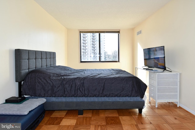 bedroom featuring parquet flooring