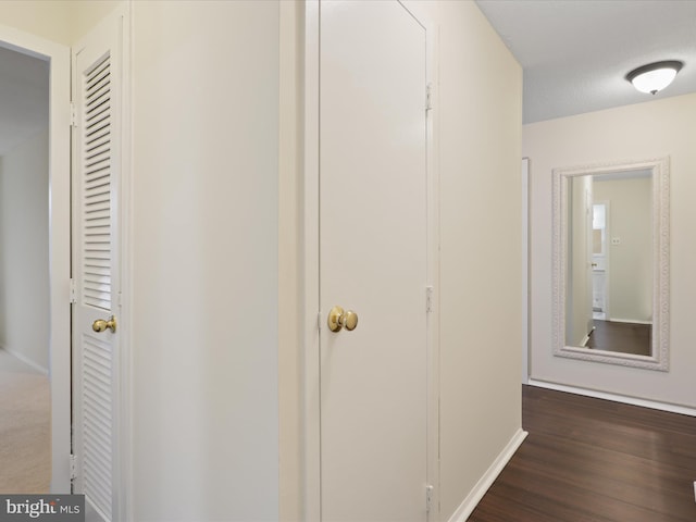 corridor with dark wood-type flooring