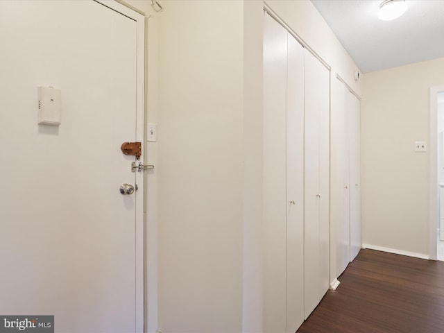 hallway with dark wood-type flooring