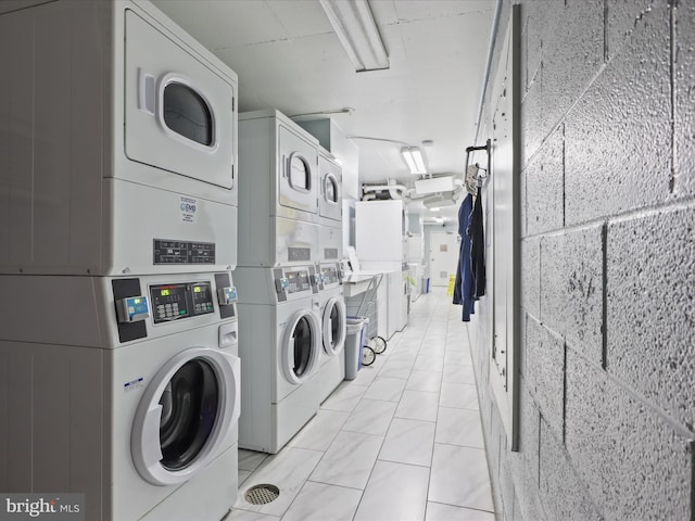 laundry room featuring washing machine and dryer and stacked washer and clothes dryer