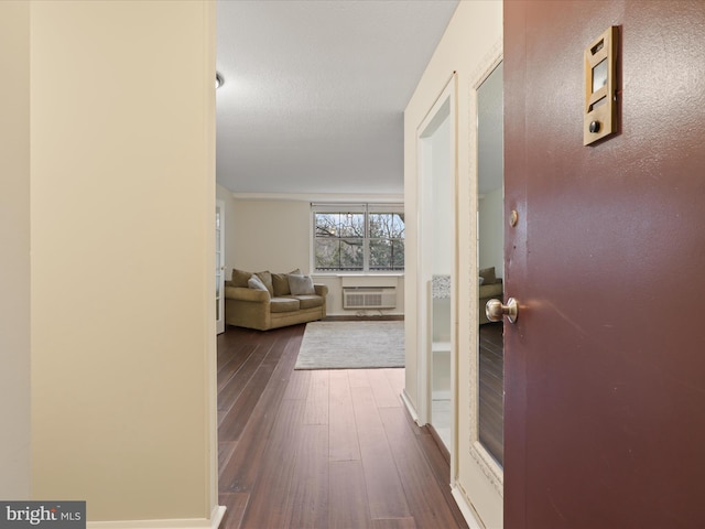 hallway featuring dark hardwood / wood-style floors and a wall unit AC