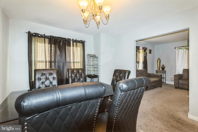 carpeted living area featuring an inviting chandelier and baseboards