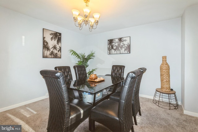 dining area featuring carpet floors, baseboards, and a chandelier