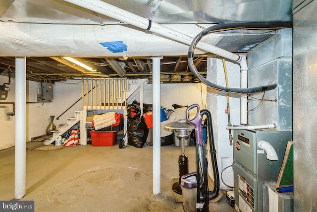 unfinished basement with stairs and electric panel