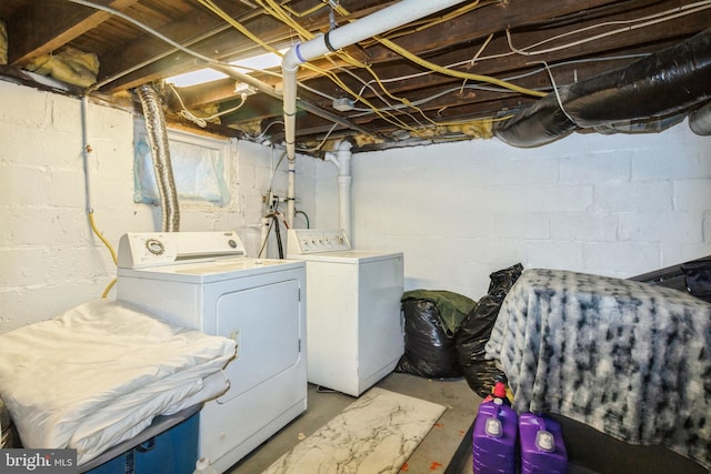 clothes washing area featuring laundry area and washing machine and clothes dryer