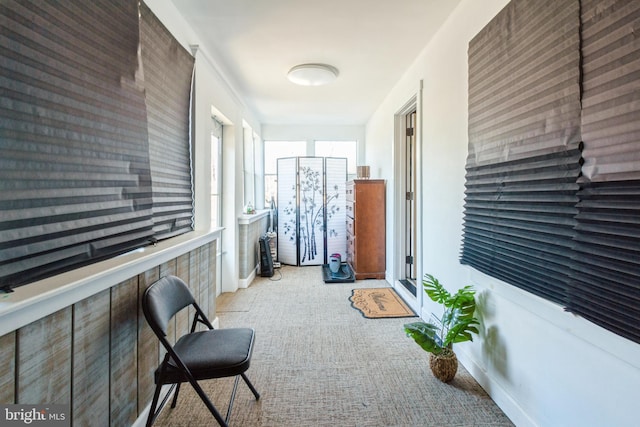 corridor featuring light colored carpet