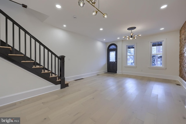 entrance foyer with a chandelier and light hardwood / wood-style flooring