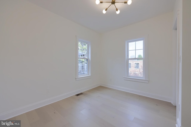 unfurnished room featuring plenty of natural light and light hardwood / wood-style flooring