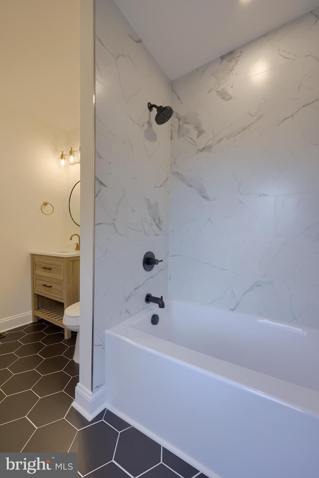 full bathroom featuring vanity, toilet, tiled shower / bath combo, and tile patterned flooring