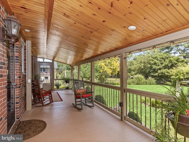 sunroom featuring wooden ceiling