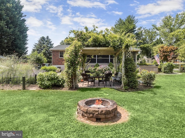 view of yard with an outdoor fire pit and a patio area