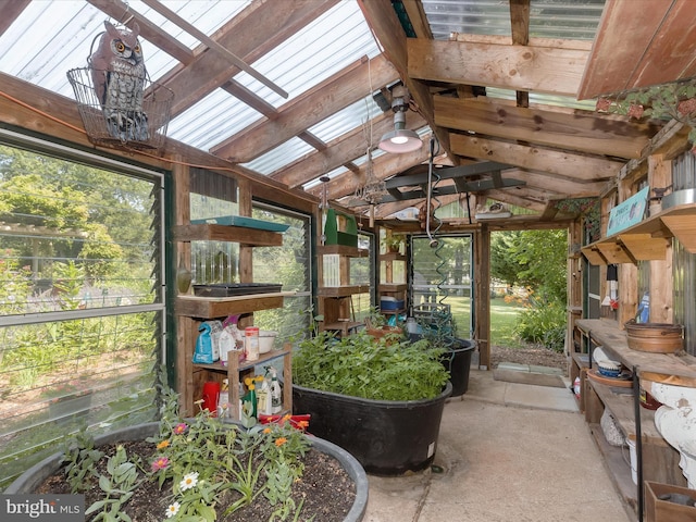 sunroom / solarium featuring lofted ceiling with skylight