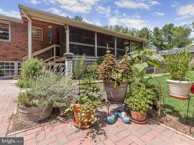 view of patio / terrace featuring a sunroom