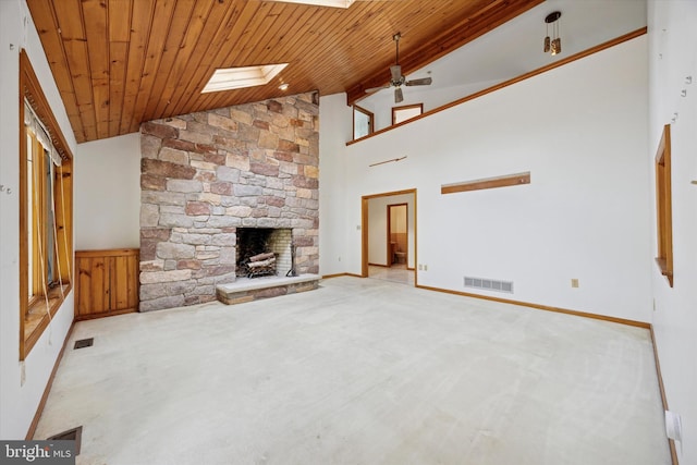 unfurnished living room featuring a stone fireplace, carpet, wood ceiling, high vaulted ceiling, and a ceiling fan