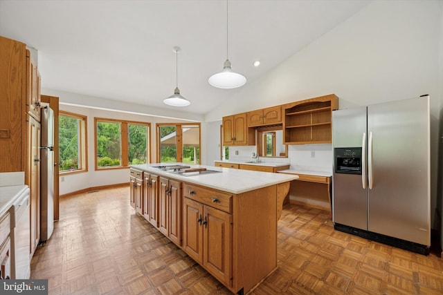 kitchen with stainless steel refrigerator with ice dispenser, light countertops, open shelves, pendant lighting, and a kitchen island