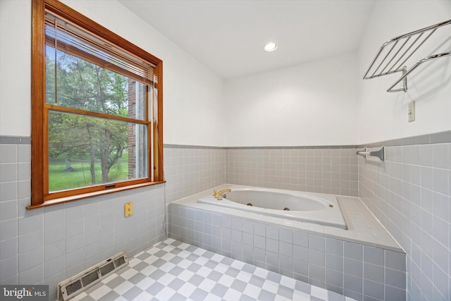 full bathroom featuring a whirlpool tub, tile walls, wainscoting, and recessed lighting
