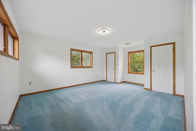unfurnished bedroom with carpet, baseboards, and a closet