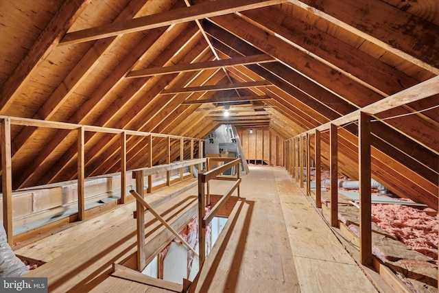 unfinished attic featuring an upstairs landing