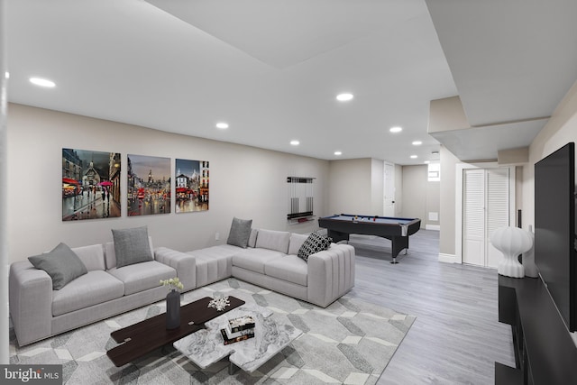 living room with pool table and light hardwood / wood-style floors