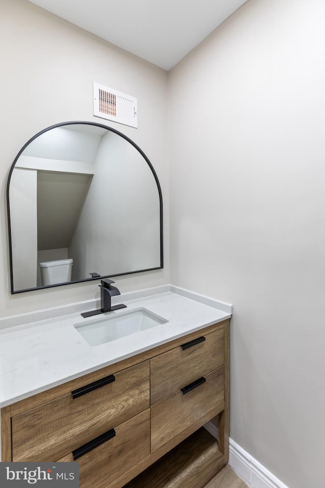 bathroom with vanity and toilet