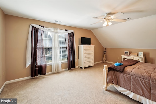 bedroom featuring vaulted ceiling, light colored carpet, and ceiling fan