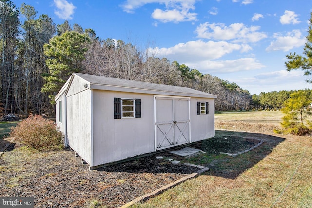 view of outbuilding featuring a yard