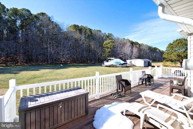 wooden deck with a yard and a storage shed