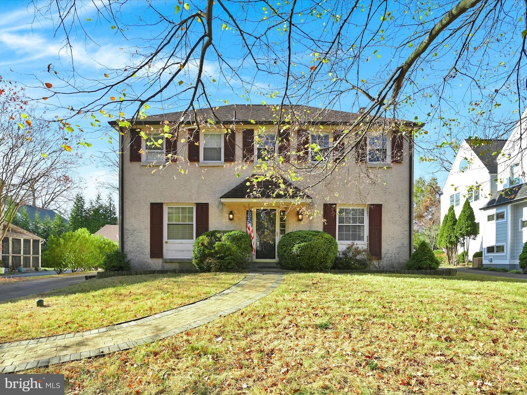 colonial-style house with a front yard