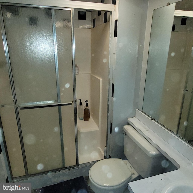 full bath with a shower stall and toilet