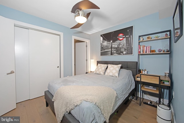 bedroom featuring ceiling fan, a closet, and light hardwood / wood-style flooring