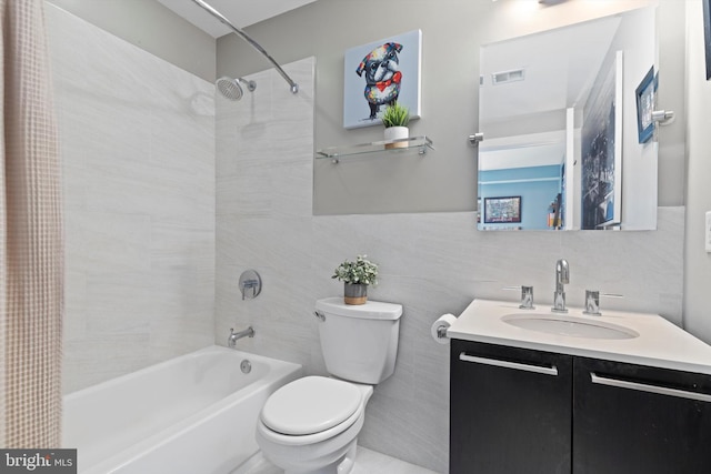 full bathroom featuring vanity, toilet, shower / tub combo, and tile walls