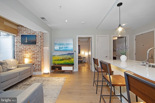 living room featuring sink and light wood-type flooring