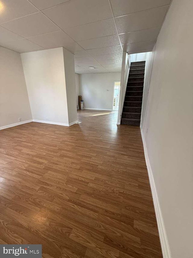 unfurnished room featuring hardwood / wood-style floors and a drop ceiling