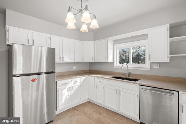 kitchen featuring a sink, open shelves, appliances with stainless steel finishes, and white cabinetry