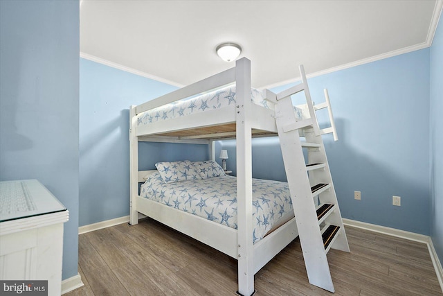 bedroom featuring crown molding and hardwood / wood-style floors