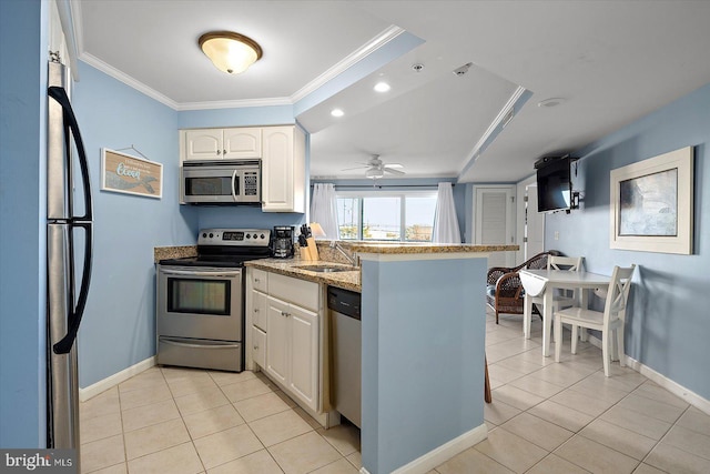 kitchen with sink, light tile patterned floors, ornamental molding, stainless steel appliances, and white cabinets