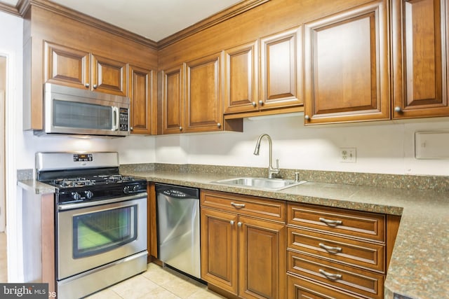 kitchen featuring sink, light tile patterned floors, stainless steel appliances, and light stone countertops