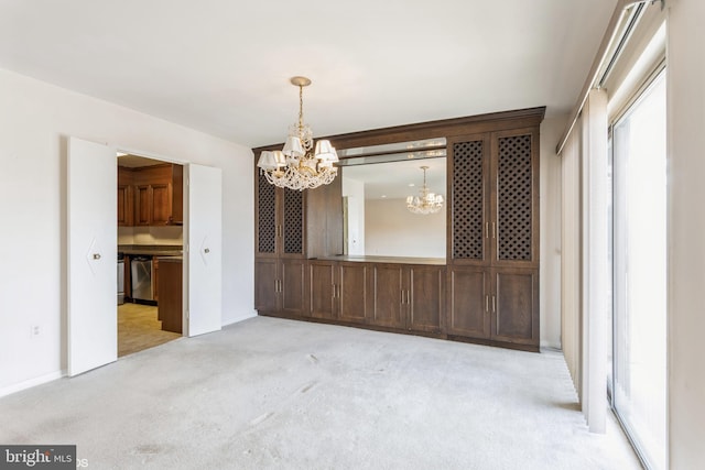 unfurnished dining area featuring light carpet and a notable chandelier