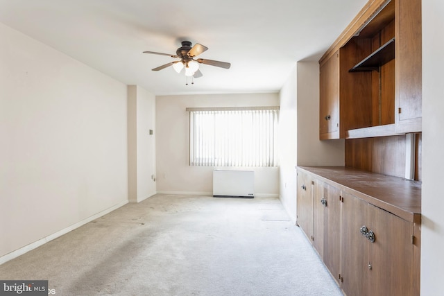 kitchen featuring light carpet and ceiling fan