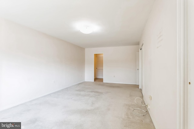 spare room featuring light colored carpet