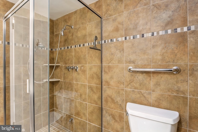 bathroom with walk in shower and toilet